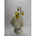 A German Porcelain Figurine, with delicate lace-work dress, factory marks to base, approx 30 cms.
