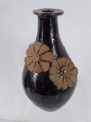 R. Higgs for Winchcombe Pottery, brown glazed vase, with daisy's in relief, approx 27 cms, with