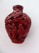 An Antique Chinese Cinnabar Scent Bottle, hand carved with figures in a landscape, approx 6.3 cms