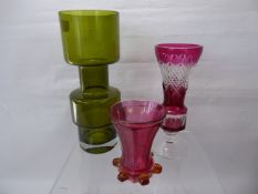 Three Glass Vases, one in green, approx 28 cms, together with a cranberry cut glass vase, approx
