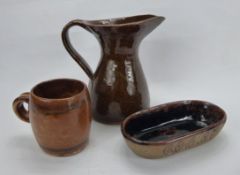 R. Higgs for Winchcombe Pottery, a ochre glazed milk jug with incised decoration to handle approx 16
