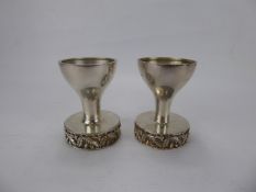 A Pair of House of Lawrian Silver Gilt Candle Holders, London hallmark, dated 1978, decoration