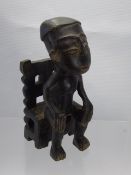 A Wood-Carved Tribal Figure depicted seated on a chair (possibly from Ghana), approx 22 cms.