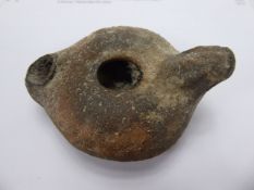 A Roman Tetrracotta Oil Lamp.