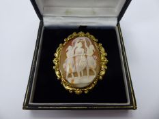 An Antique Shell Cameo Brooch, depicting the three graces, the Cameo being set in a 14 ct yellow