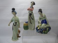 Three Japanese Shi Wan Feminine Figurines, depicted carrying fish, feeding ducklings and reading