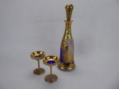 A Bohemian Cobalt Glass Decanter Set, with six stem glasses, hand painted with vine and grapes.
