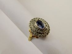 An 18 ct Yellow and White Gold Sapphire and Diamond Ring. The diamond set in scroll mount, size M,