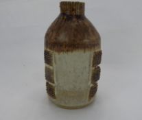 R. Higgs for Winchcombe Pottery, Bottle Vase, with cream glaze and square decoration in relief,