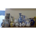 Twelve Portuguese Ceramic Jugs, of various sizes and styles, hand-painted in typical fashion.