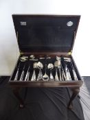 A Cooper Ludlow Eight Piece Silver Plated Cutlery Set, in mahogany effect stand.