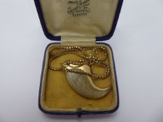 An Antique Dew Claw Pendant set in a 14 ct gold engraved mount, total approx wt 8.6 gms, on a 9 ct