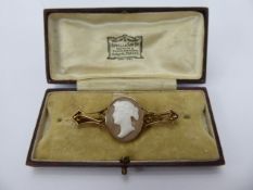 A 9ct Gold Shell Cameo Bar Brooch, depicting a classical figure.