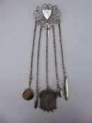 A Silver Five-Piece Chatelaine, the Chatelaine comprising of a mirror, pencil, tape measure, purse