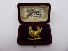 An 18ct Yellow Gold Bird Brooch, the bird having ruby set eyes with a diamond, sapphire and ruby