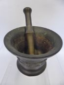 An Early 18th Century English Bronze Apothecary Pestle and Mortar, the waist applied with shell