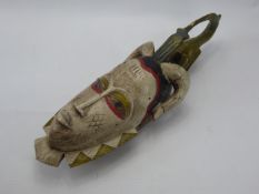 A North African Wooden Feminine Mask in polychrome with Ibis Headress, approx 53 x 17 cms (af).