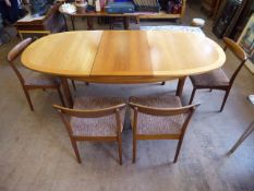 A Solid Nathan Teak Six Seater Extendable Dining Room Table, with four chairs. The table measures 97