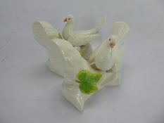 A Pair of Porcelain Bookends, in the form of doves seated on a branch, approx 19 x 16 cms.