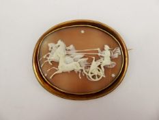 An Antique Shell Cameo Brooch, carved with Helios beneath the night sky, approx 6 x 5 cms, contained