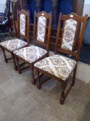 Six 'Old Charm' Dining Chairs, two carvers and four straight chairs with tapestry upholstery.