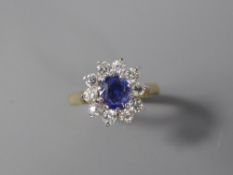 A Lady's 18ct Yellow Gold Sapphire and Diamond Ring. The central sapphire measuring approx 6 x 5