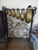 An Oriental Glockenspiel with six graduated bells on a wrought iron stand, approx 84 cms high.