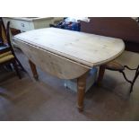 A Vintage Pine Drop Leaf Table, on turned legs, approx 134.5 cms dia x 76 cms high.