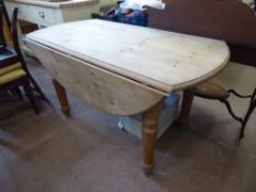 A Vintage Pine Drop Leaf Table, on turned legs, approx 134.5 cms dia x 76 cms high.