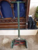 A Vintage 'British Flexa' Lawn Mower with wooden handle.