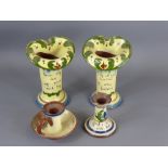 Four items of Torquay Ware, including two vases and two candle holders.