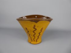 A Winchcombe Pottery Earthenware yellow and brown-decorated glazed oval wall vase, unidentified,