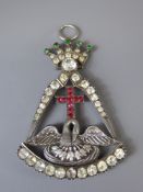 A Silver White, Red and Green Stone Masonic Style Pendant, the pendant having a figurative swan to