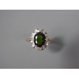 An 18ct Yellow Gold Green Tourmaline and Diamond Ring. The tourmaline measuring approx 9 x 7 mm
