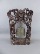 A Tibetan Brass Temple Prayer Bell suspended from a hardwood stand inlaid with wire, approx 48 cms