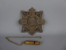 A Victorian Cast Iron Commemorative Trivet together with a circa 1907 brass whistle on brass lanyard