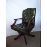 A Contemporary Chesterfield Green Leather Captain's Chair, (height can be adjusted).