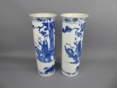 A Pair of 19th Century Chinese Blue/White Pillar Vases, depicting figures in a garden with