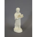 A White Porcelain Boy holding a plate and bowl of fish, approx 13 cms.