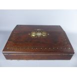 A Rosewood Writing Slope, the top inlaid with gilt and mother of pearl, and opening to reveal a