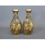 A Pair of Late 19th Century Satsuma Bottle Vases, of typical palette, hand painted raised dragon