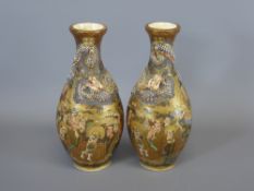 A Pair of Late 19th Century Satsuma Bottle Vases, of typical palette, hand painted raised dragon
