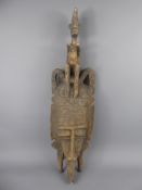 A West African Tribal Fertility Mask, elongated features with decorative headdress depicting an