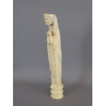 An Antique Carved Ivory Figure of 'The Madonna' praying, approx 29 cms.