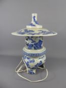A Chinese Blue and White Lamp, in the form of a temple, the lamp decorated with landscape scenes,