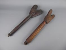 Two Wooden Short Staffs, both carved with feminine masks, the handles with incised decoration,