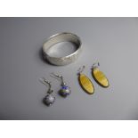 A Silver Bracelet and two pairs of drop earrings.