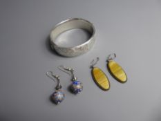 A Silver Bracelet and two pairs of drop earrings.