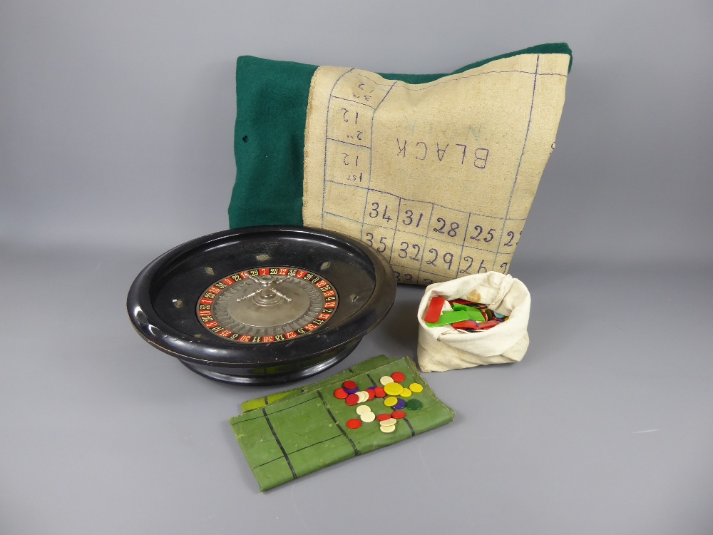 A Vintage Table-Top Roulette Wheel, together with a bag of coloured bone counters and baize together