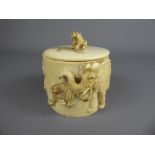 A 19th Century Ivory Cylindrical Pot and Cover, deeply carved with tigers hunting elephant, approx 7